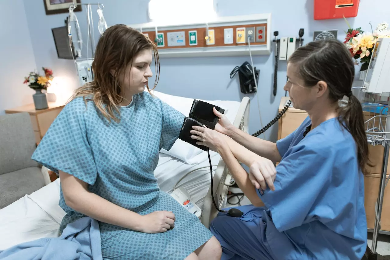 Nurse checking the patient's blood pressure